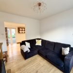 Modern living room with black corner sofa