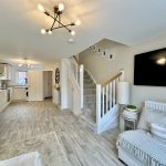 Spacious living area with modern kitchen.