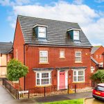 Modern red-brick house with pink door on Bow Road.